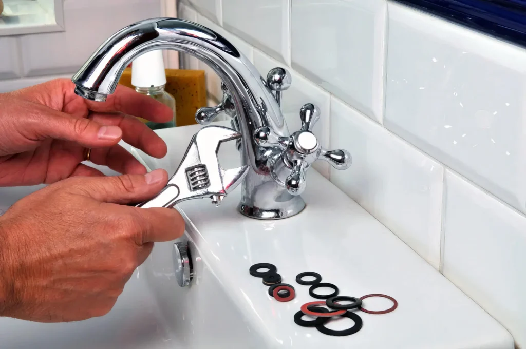 Plumber performing maintenance on a bathroom faucet in Union City