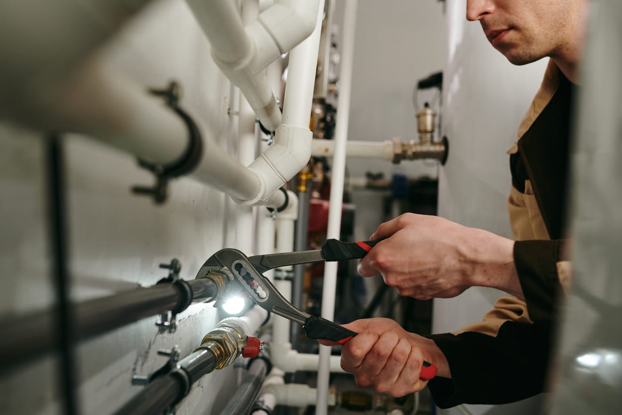 Plumbers maintaining commercial plumbing pipes in Union City
