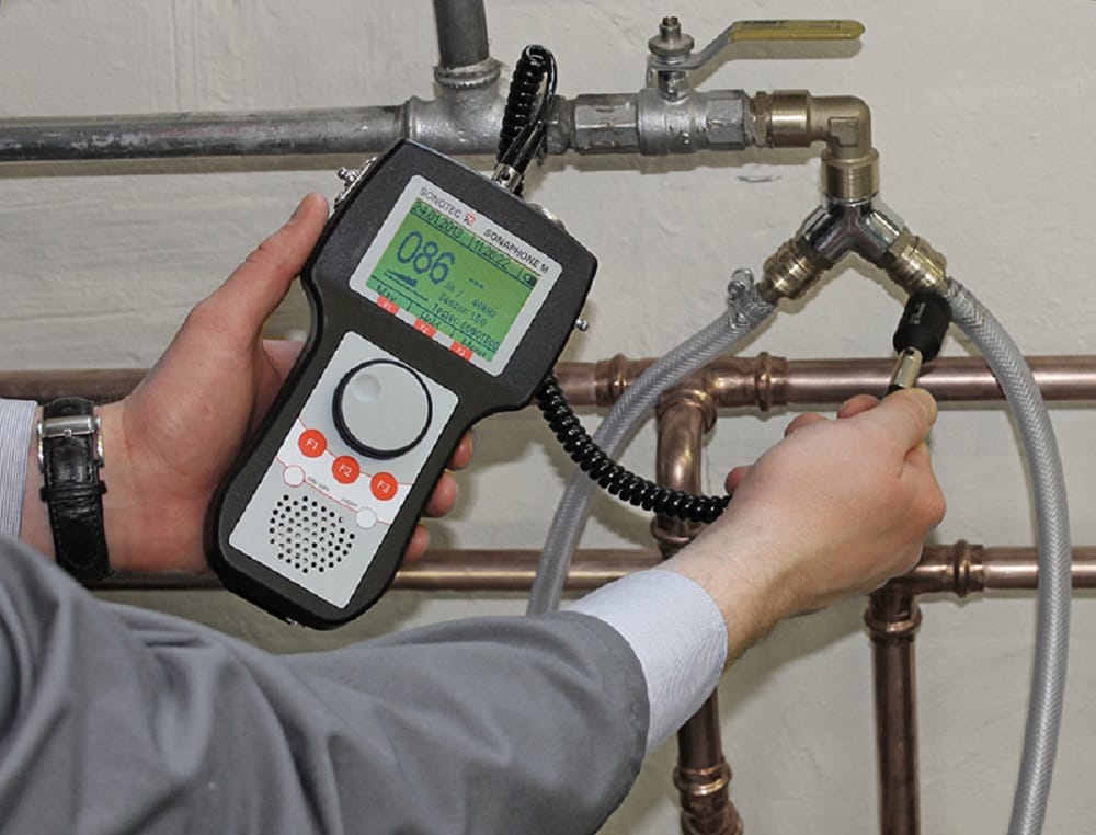 Plumber testing pipes with electronic leak detection equipment in Union City