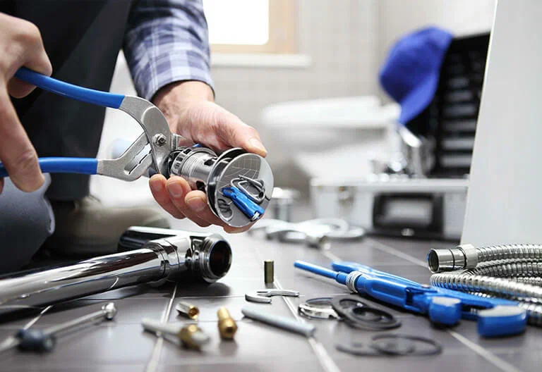 Technician repairing a plumbing fixture with professional tools in Union City