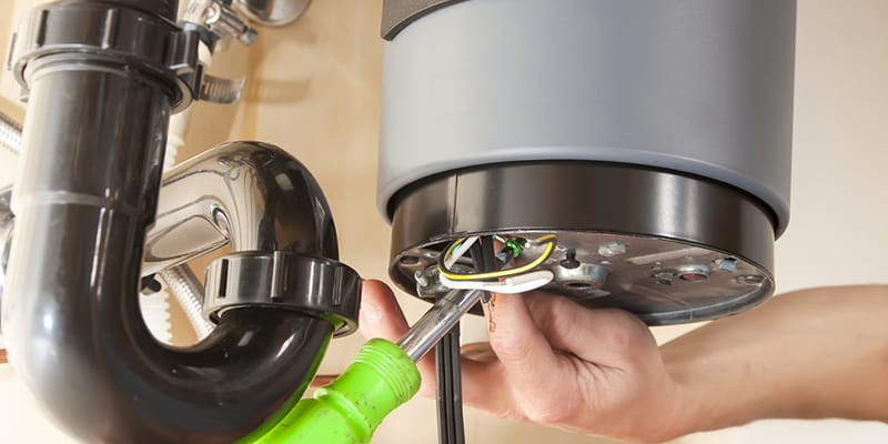 Technician repairing the heating element of a water heater in Union City