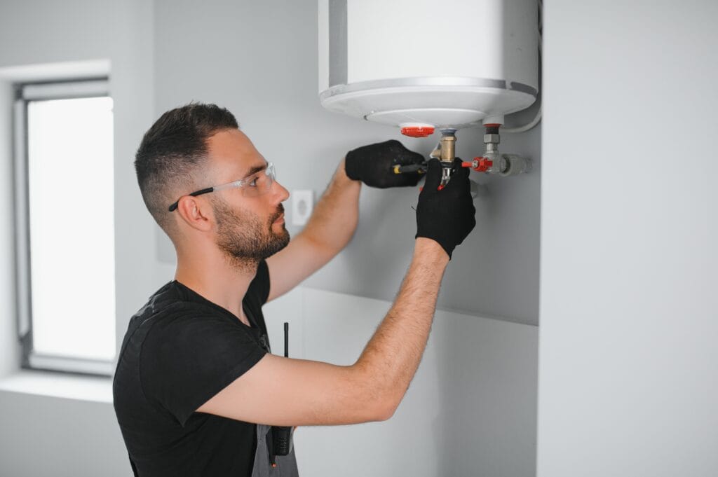 Technician performing water heater maintenance in Union City