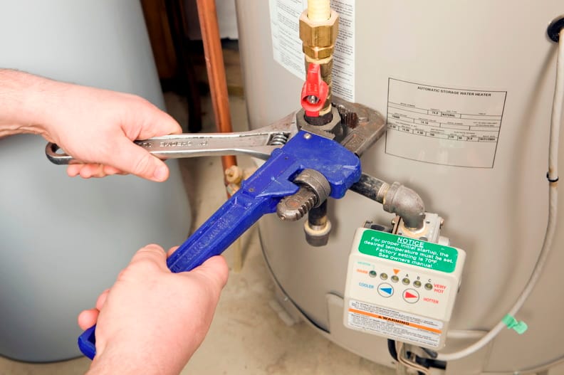 Plumber repairing a water heater valve in Union City